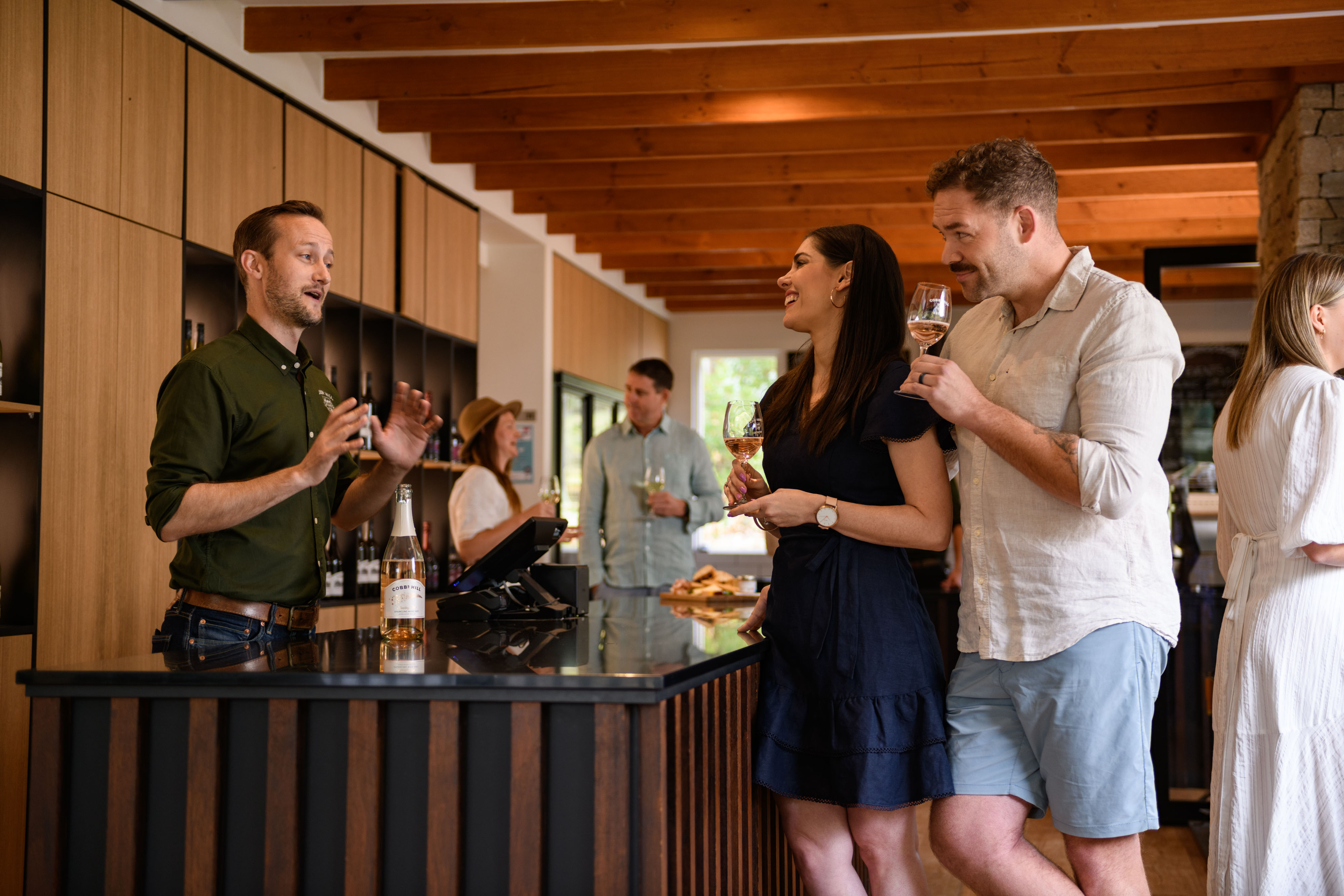 People at the bar enjoying wine 